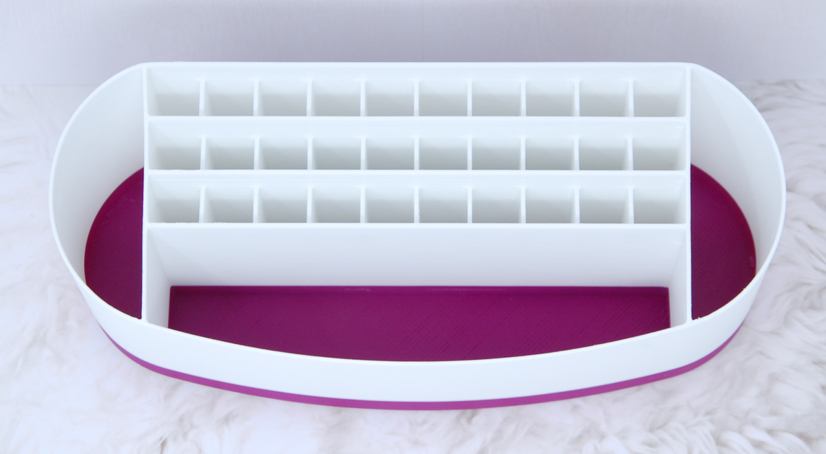 Top view of empty Cricut pen holder showing 30 slots for pens and three larger pockets shown in purple accent colour
